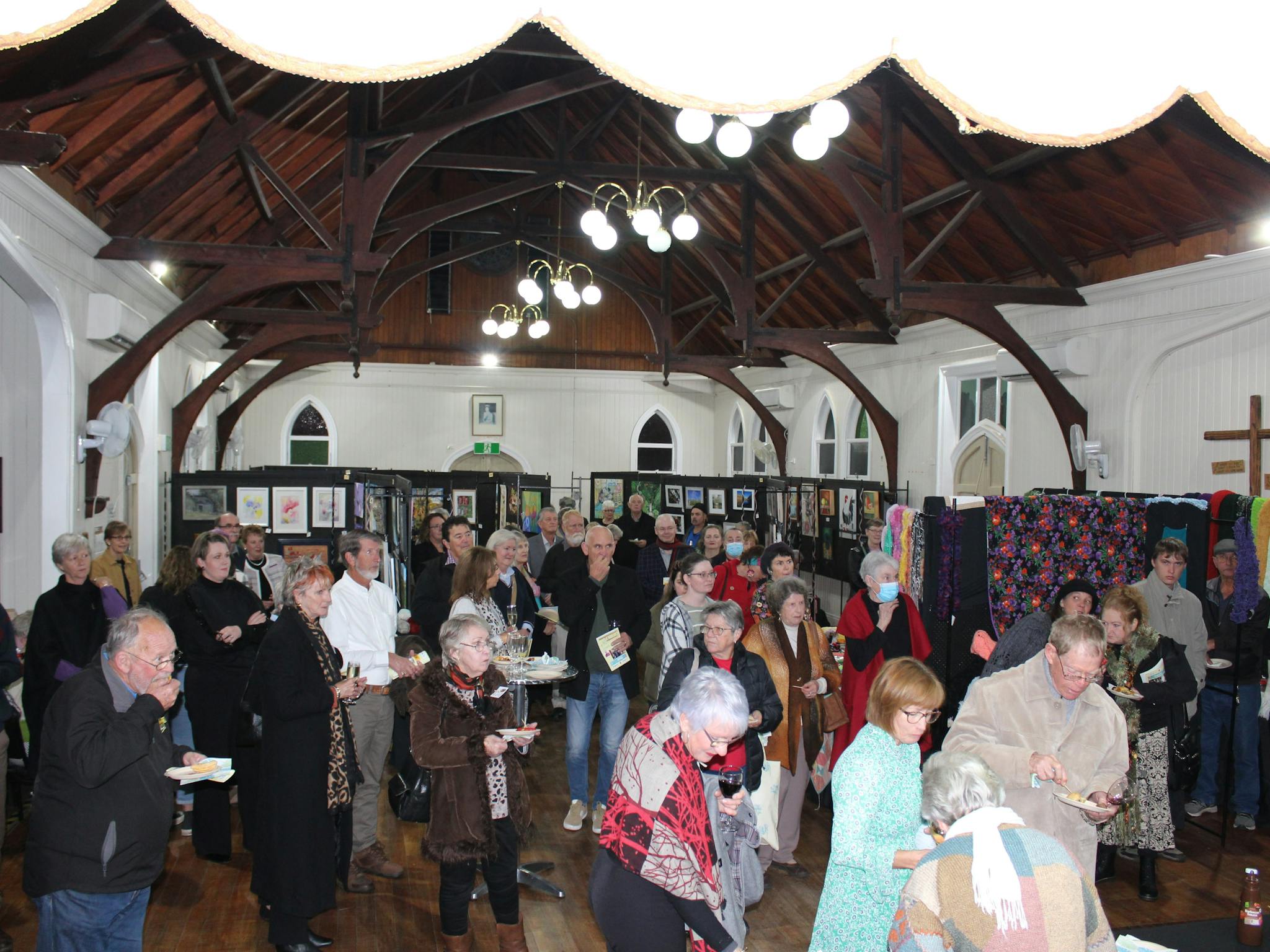 Crowds gather to view and buy art and to mingle and chat Crowds gather to view and buy art and to mingle and chat