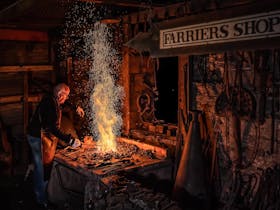 Blacksmith at work on the forge with sparks flying