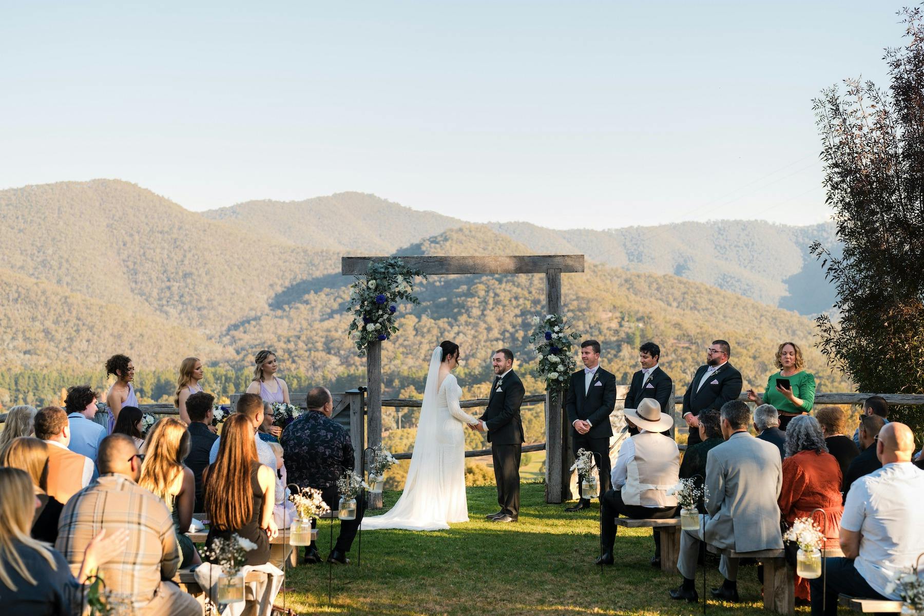 Wedding ceremony under the arbour with stunning views of Howqua Valley as a backdrop