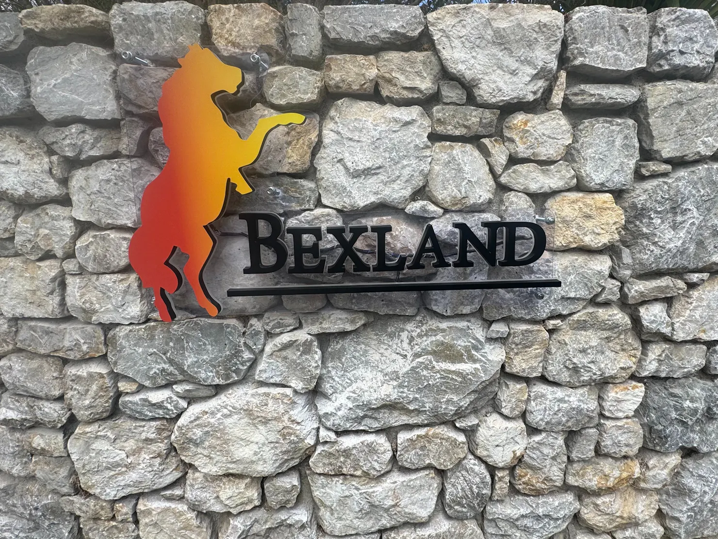 Bexland sign on Stone wall