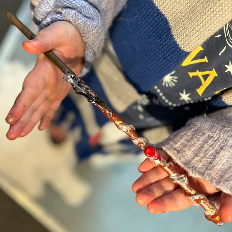 Proud wizard holding his newly made wand