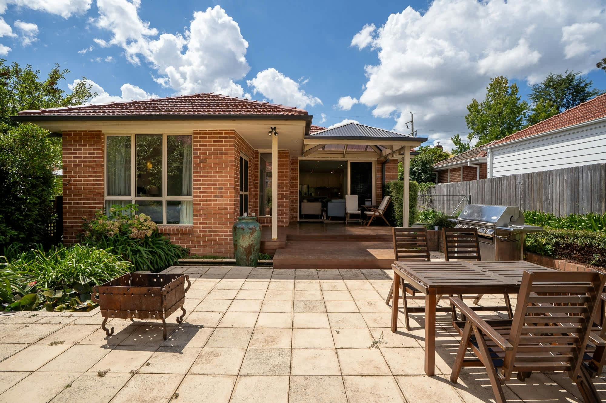 Outdoor patio area, with deck and paved undercover area.