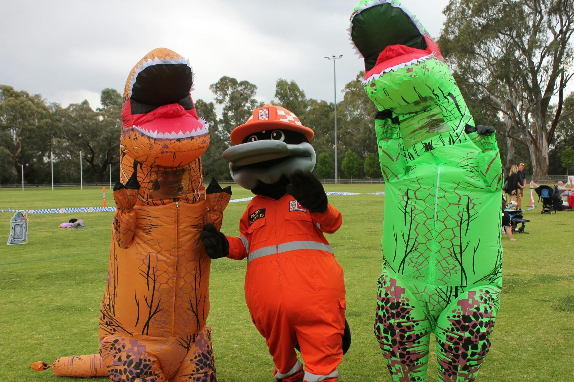 SES Mascot Paddy the Platypus with two others in inflatable dinosaur costumes