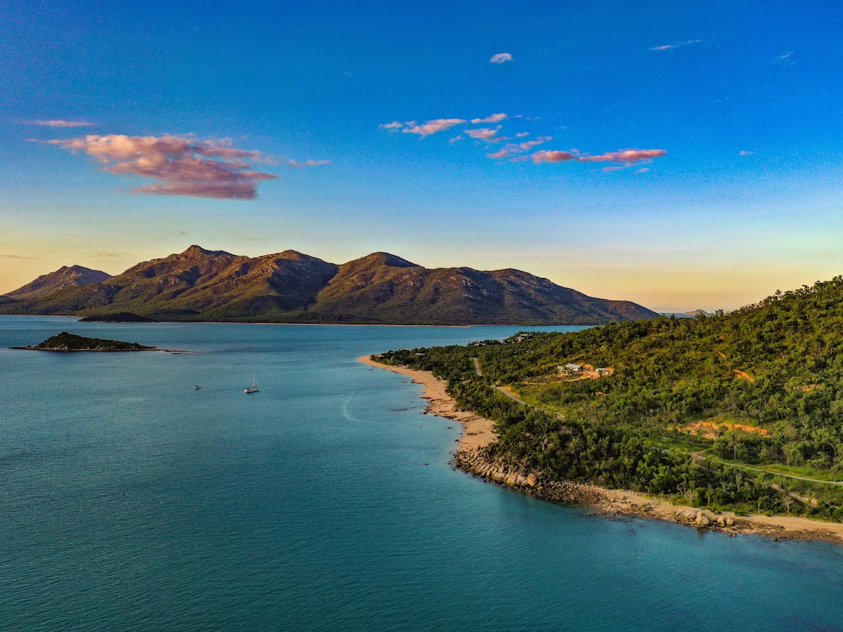 Aerial view of the coastal drive to Cape Gloucester with mountains in the background