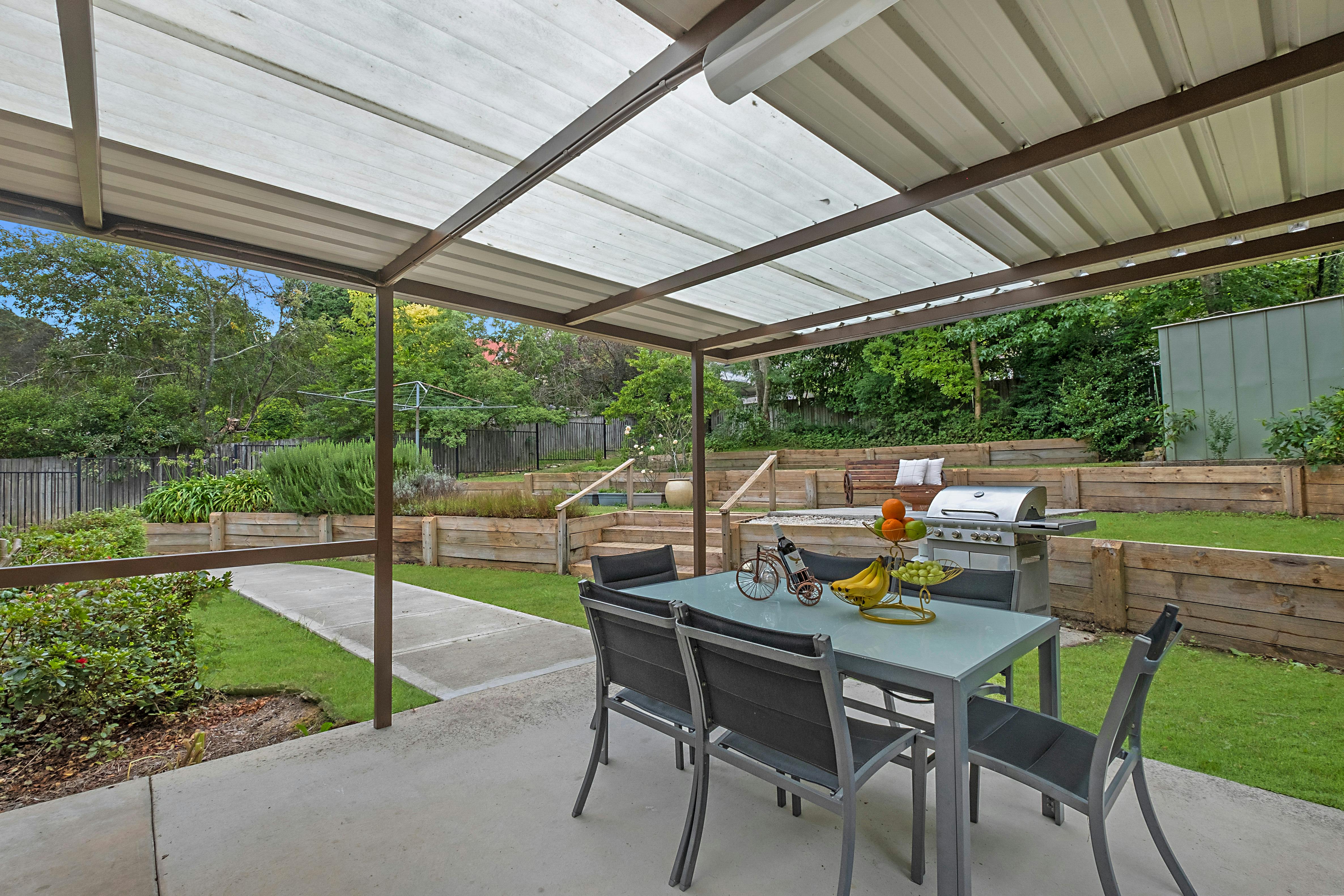 Covered, outdoor drinks and dining. Gas BBQ with five cooking hobs and spare cylinder.