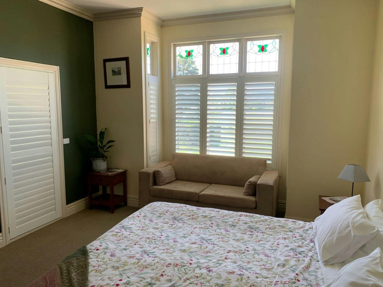 Bedroom featuring bed and a small couch at Rosedale House Mansfield