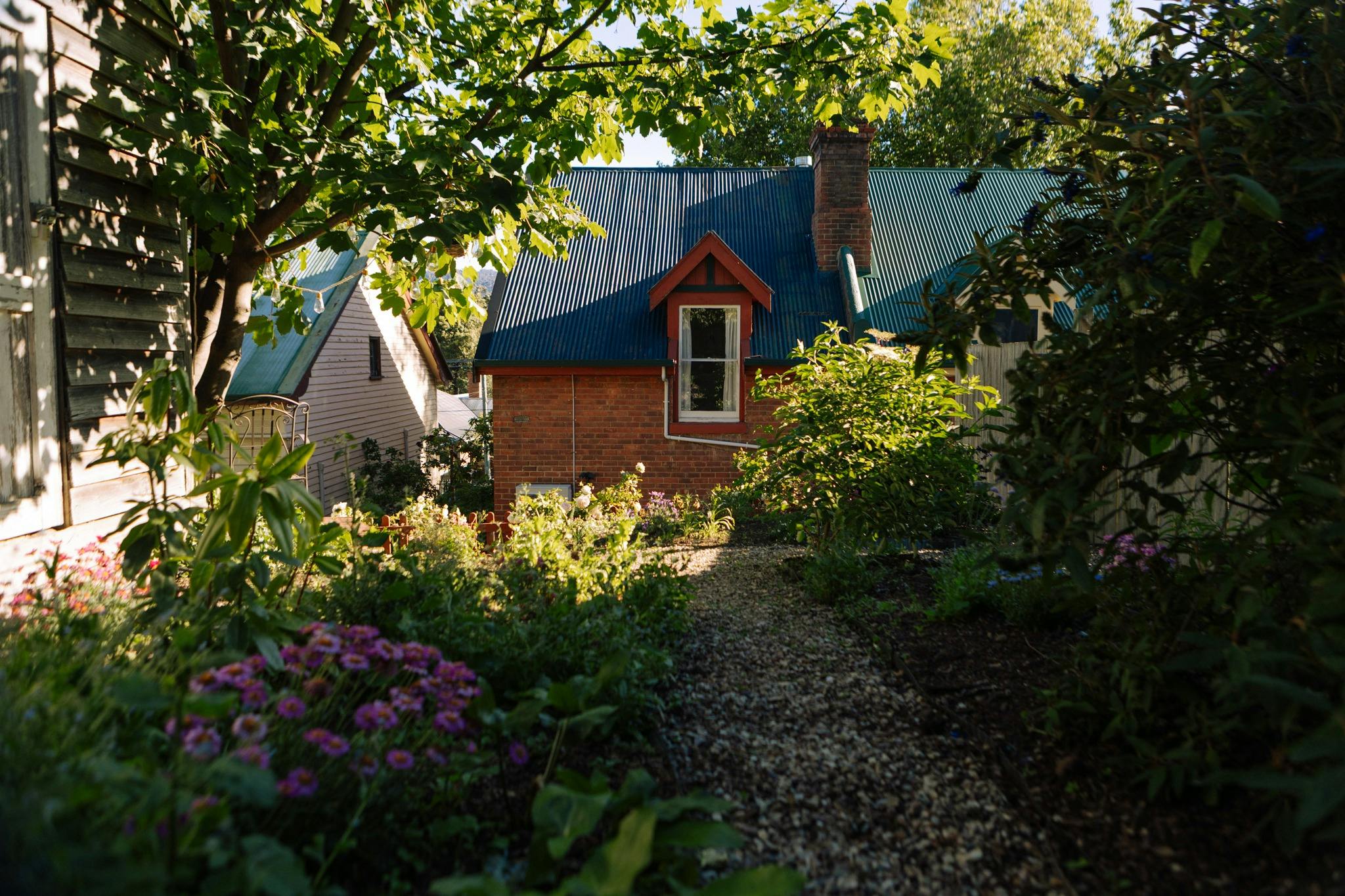 Image of the back of the house from the private garden, showing the beautiful cottage style garden