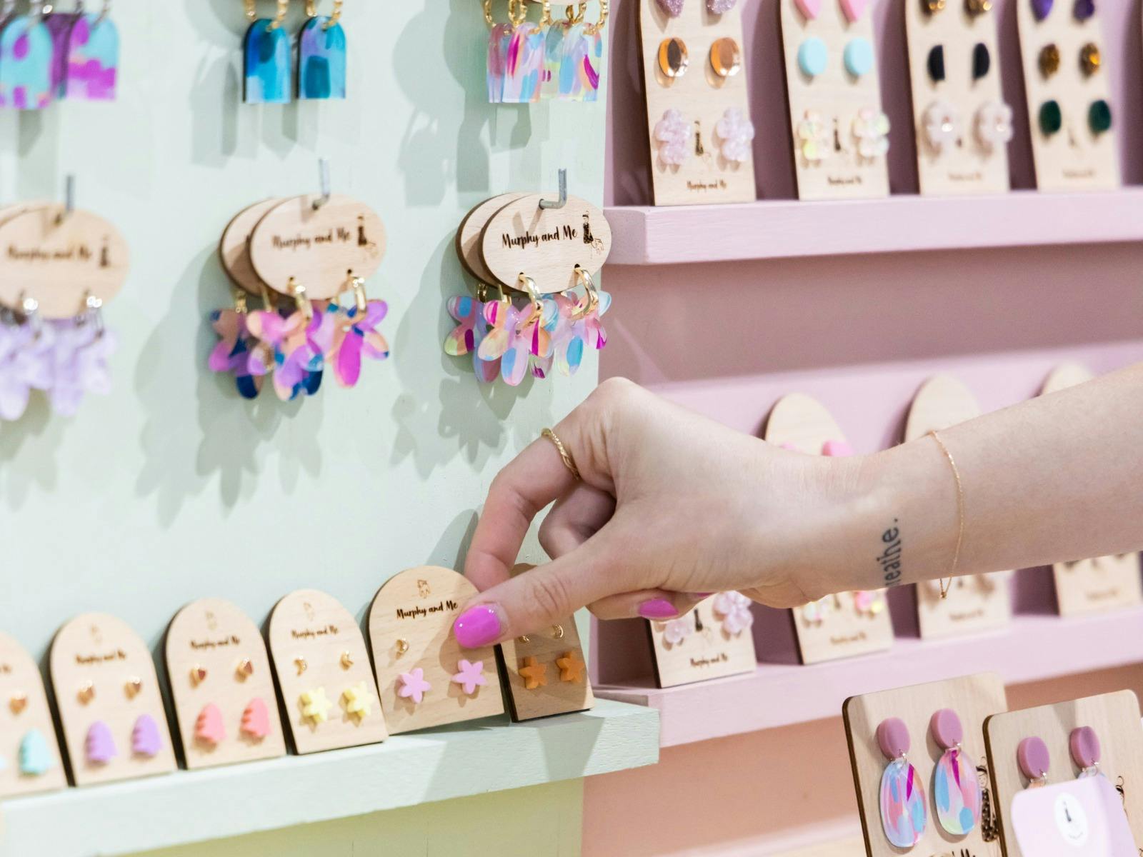 Customer picking Murphy and Me earrings