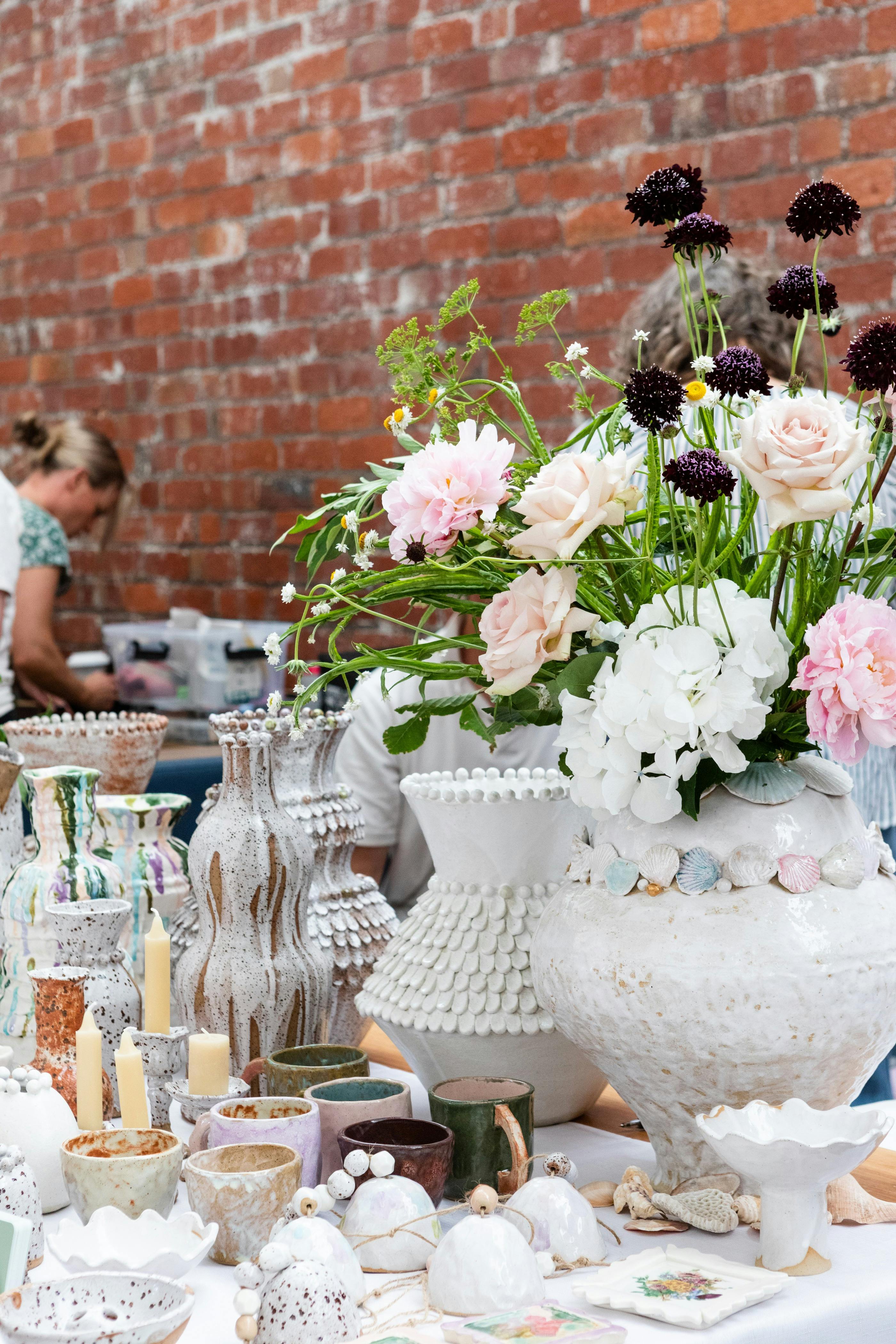 Ceramic cups and vases on display