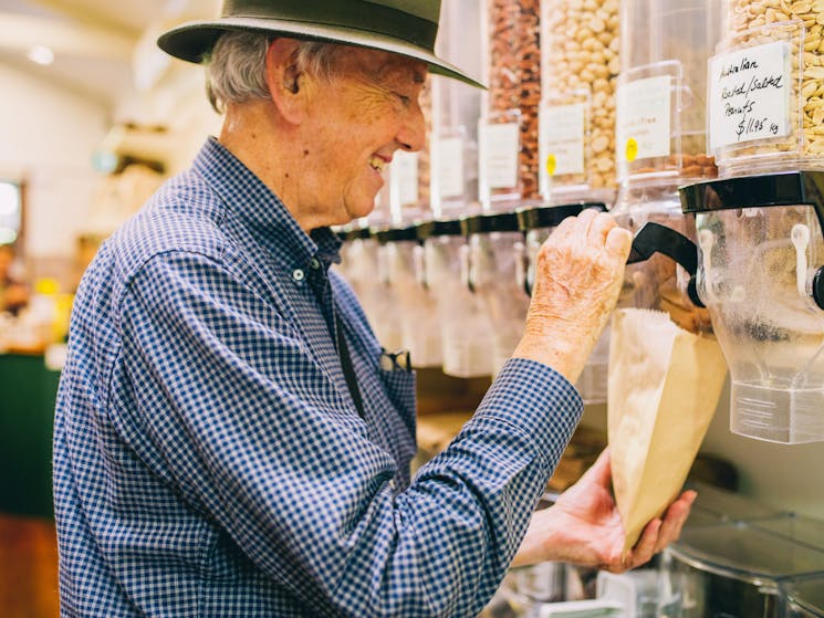 Customer serving themselves bulk food in store