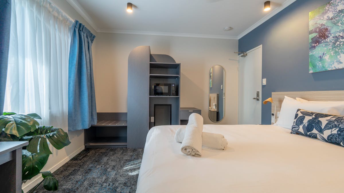A comfortable queen room with work desk and ensuite — a great choice for solo travellers and couples