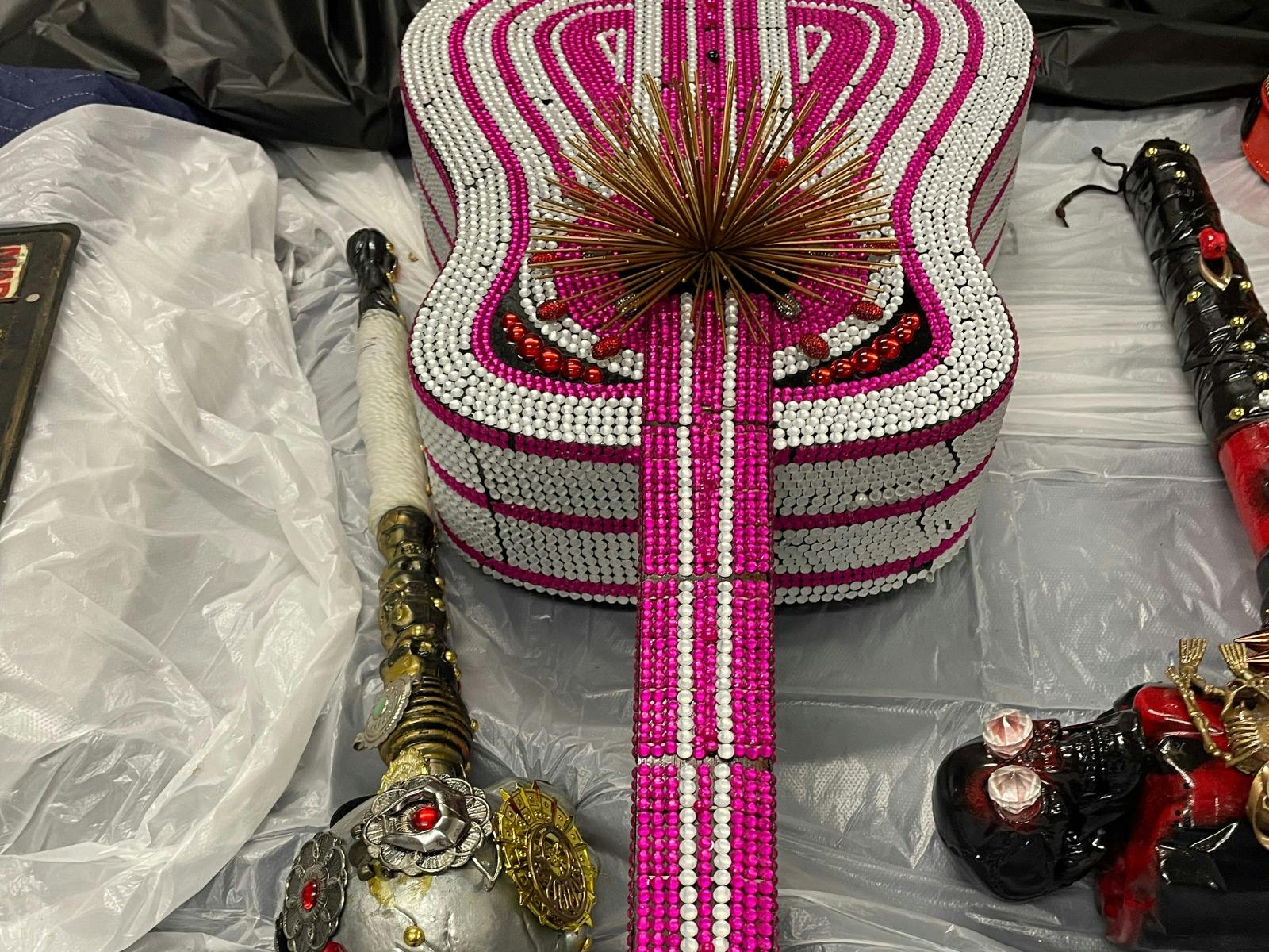 A bright pink rhinestone guitar