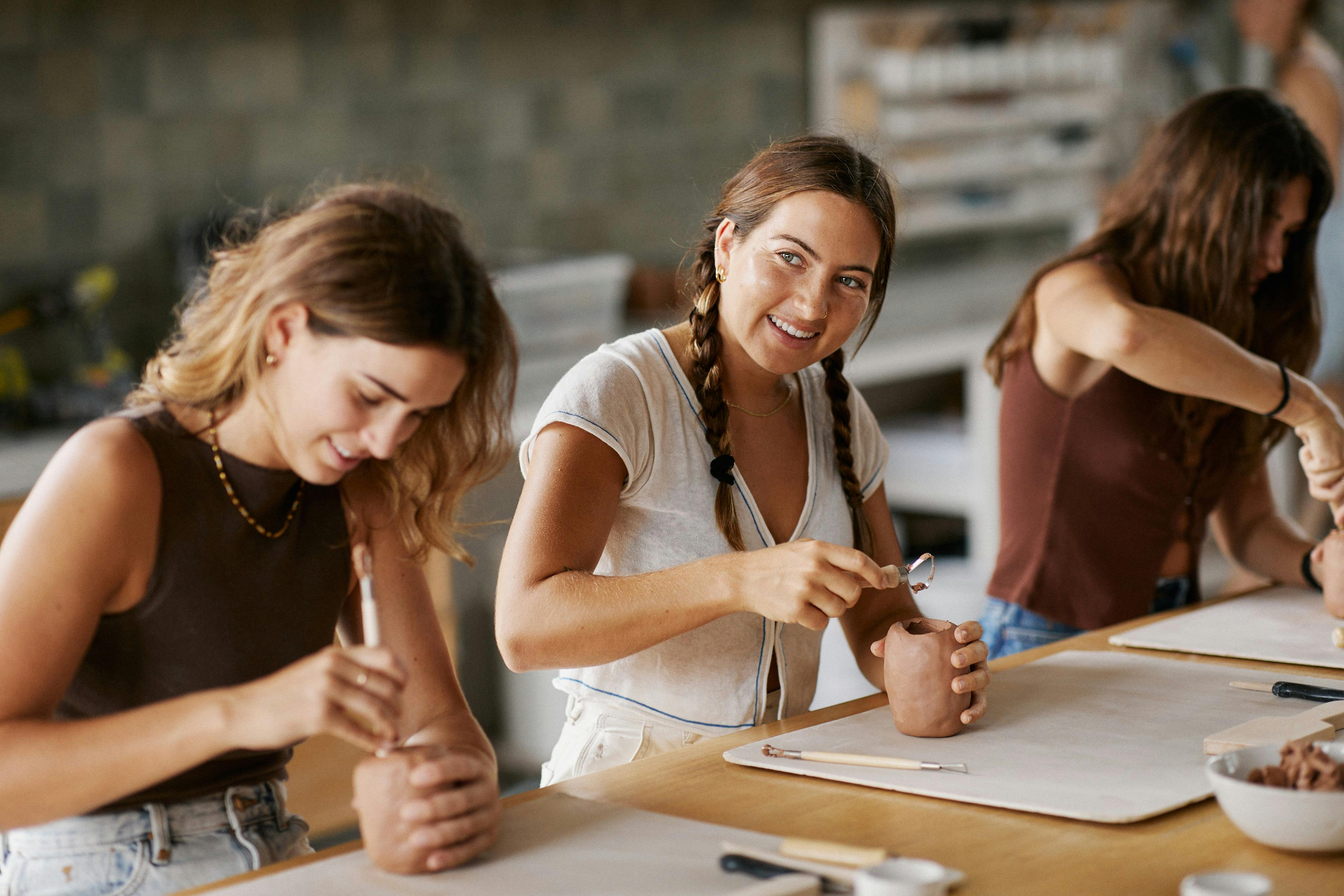 Two women doing pottery at a Crockd Studios class