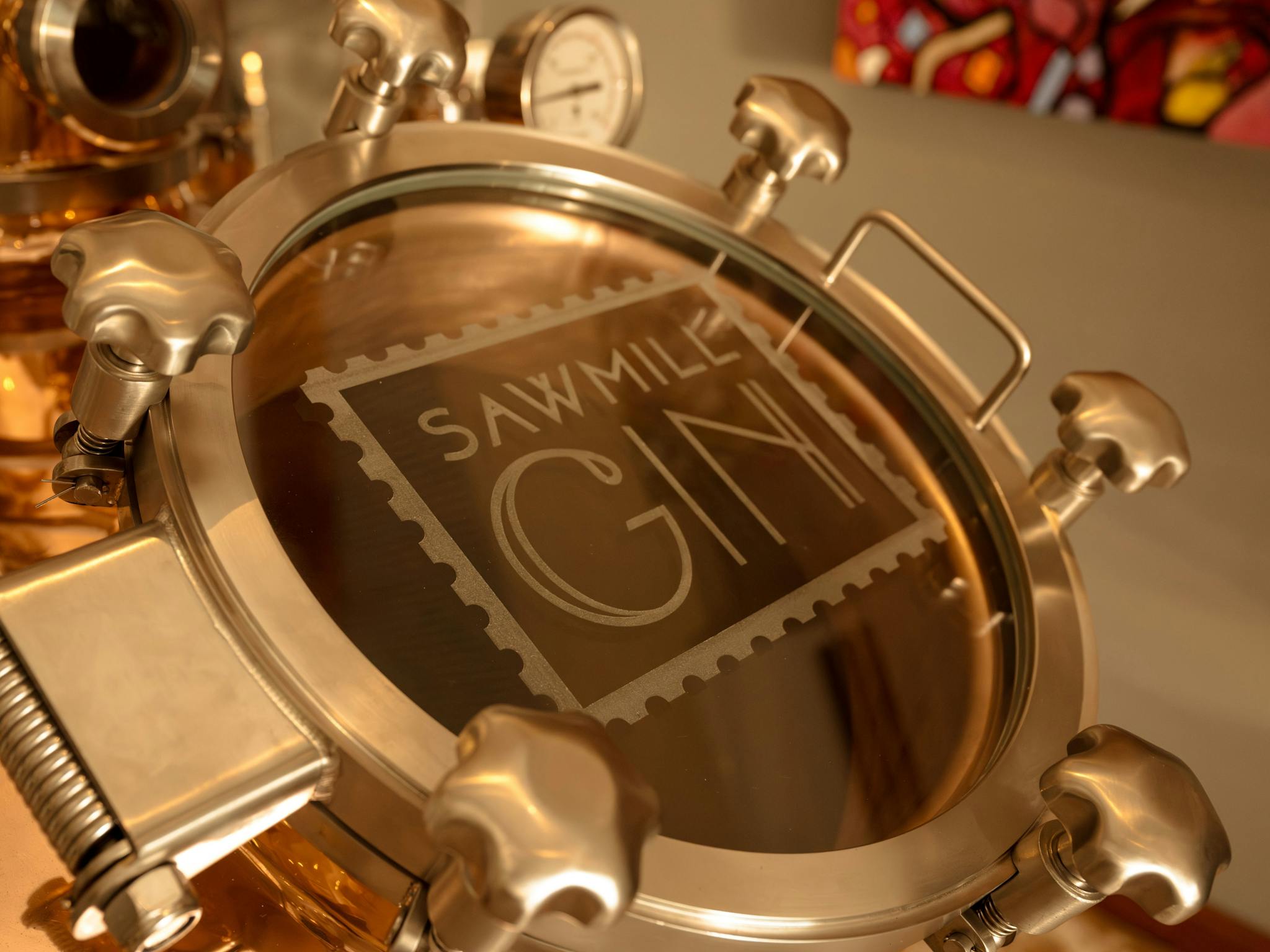 Copper Still showing manway with Sawmill gin Logo