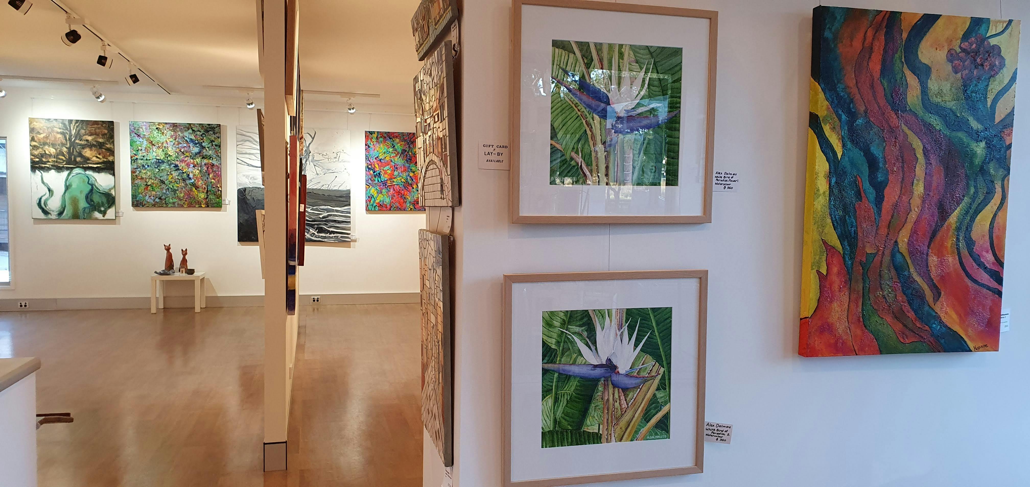 colourful artworks hanging in a gallery