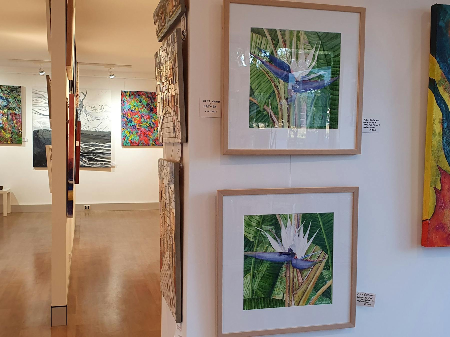 colourful artworks hanging in a gallery