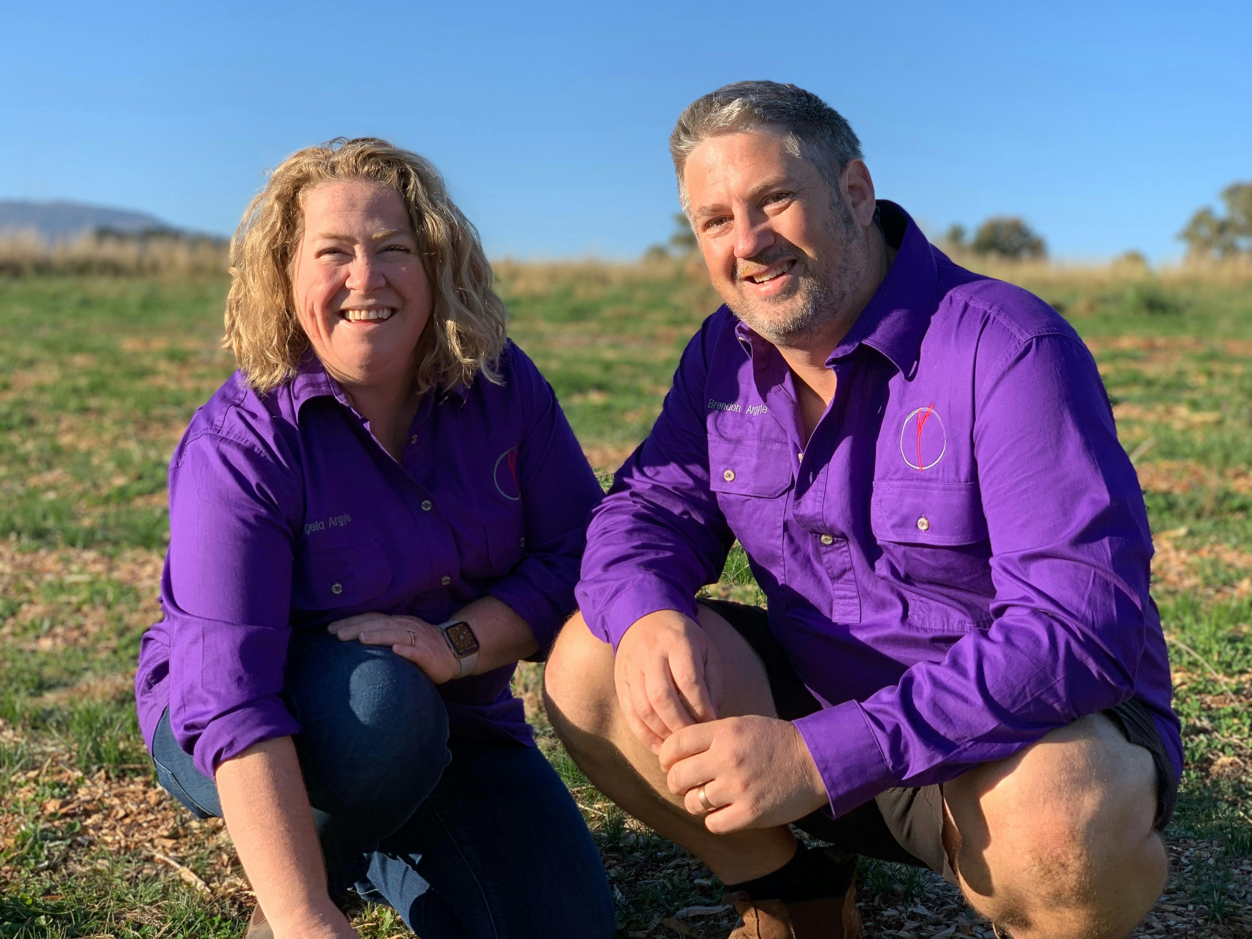 2 people kneeling in saffron field