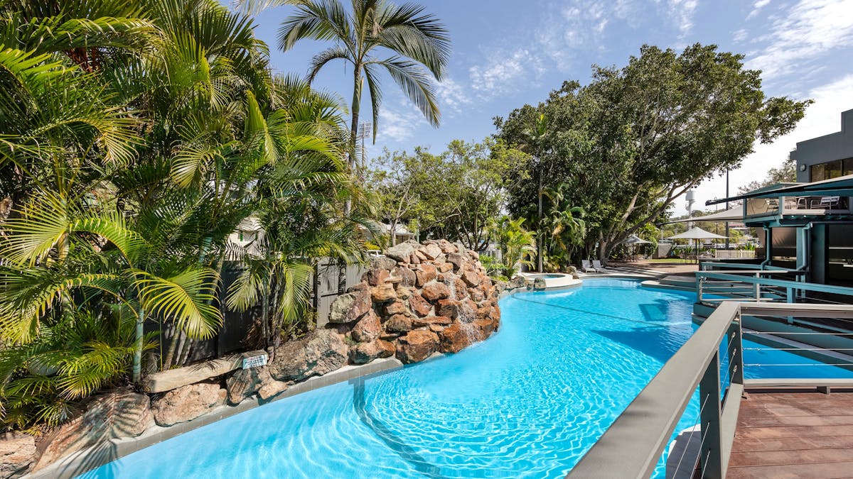 Clear blue hotel pool with deck