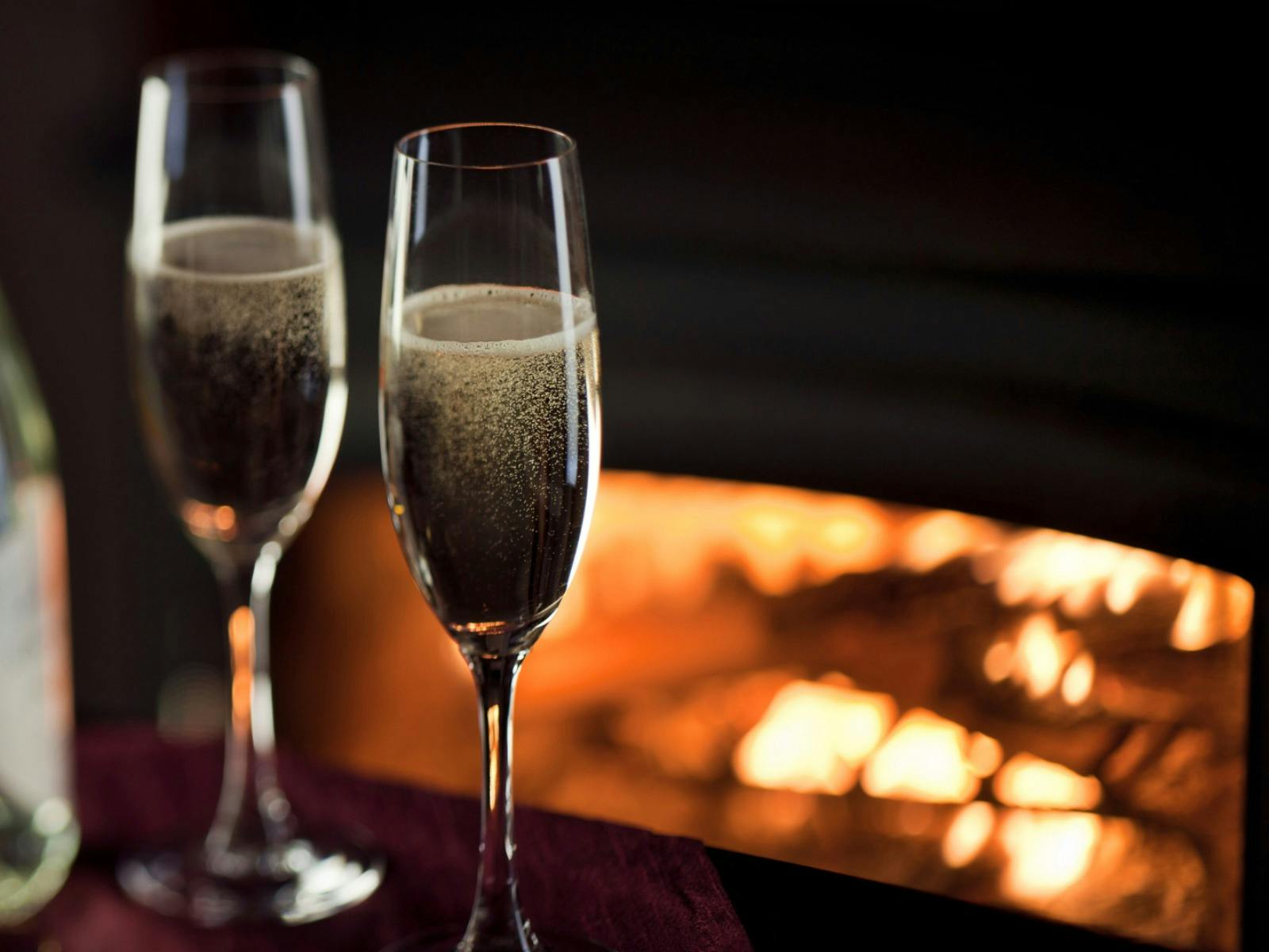 Two glasses of champagne fireside