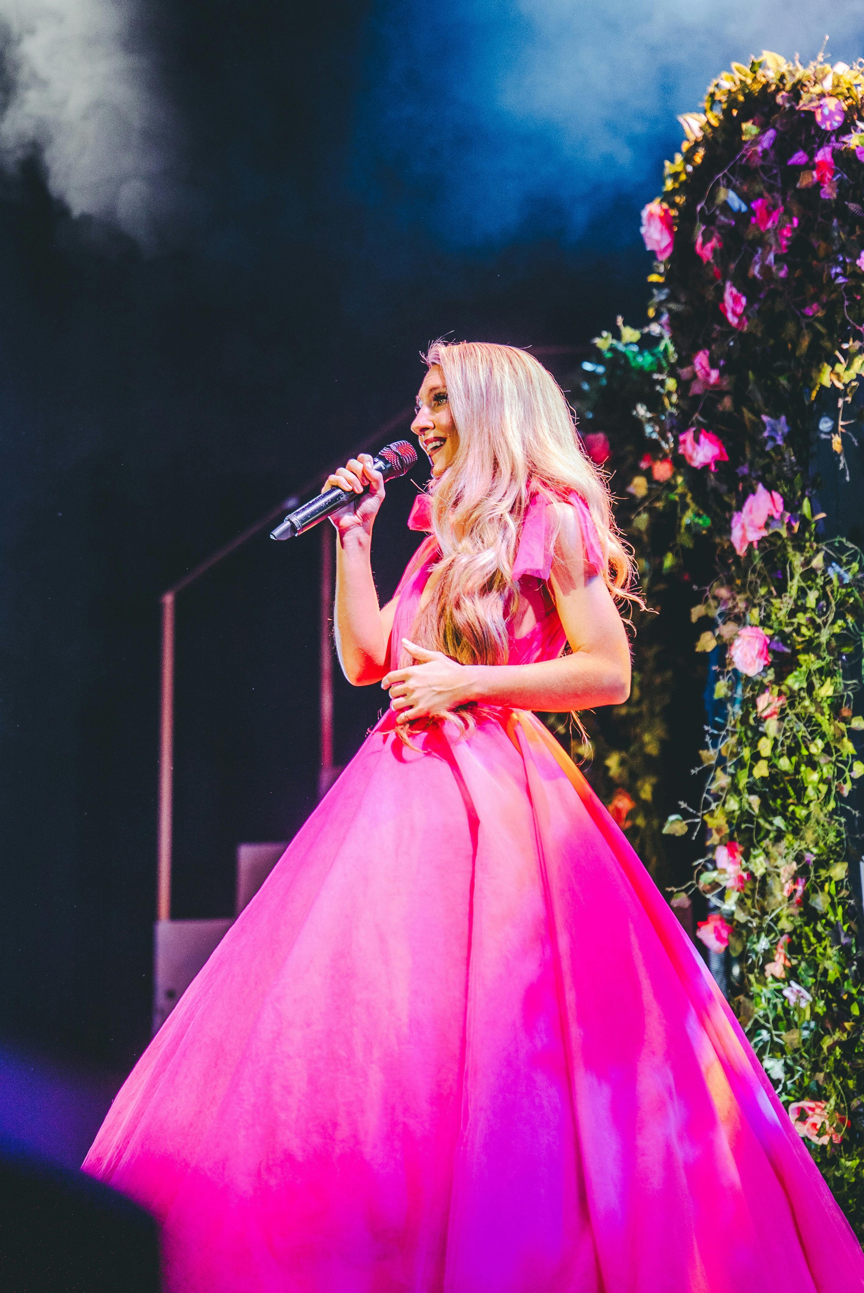 A woman dressed as a princess performing on stage.