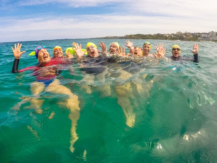 A group of OceanFit ocean swimmers enjoying a break out the back at Bondi