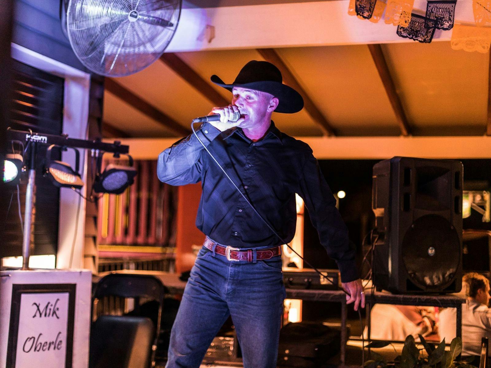 Singer performing country music on stage at Exchange Hotel Kilcoy