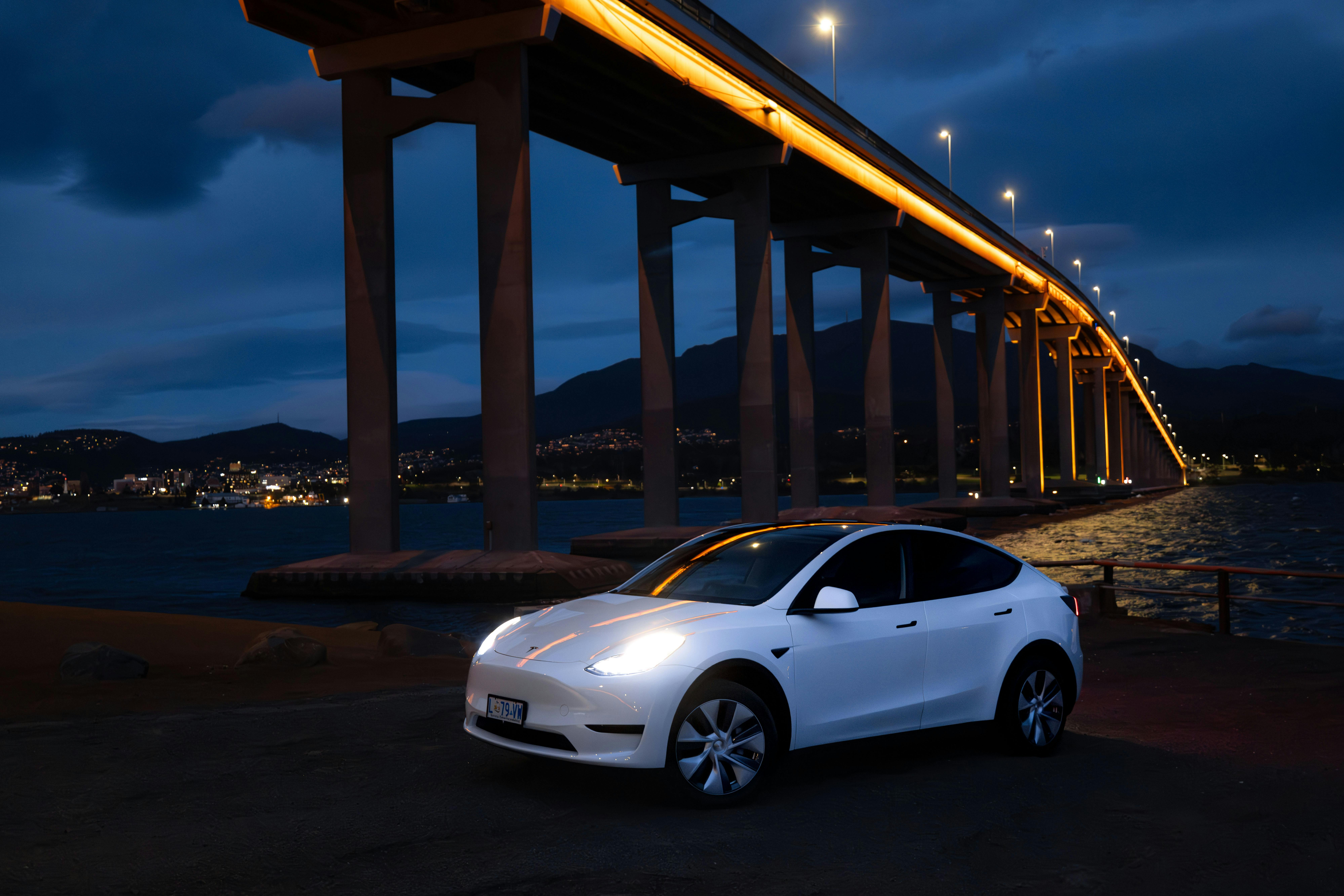 Electric Vehicle car hire (Tesla Model Y) parked adjacent to Tasman Bridge near Hobart in Tasmania.