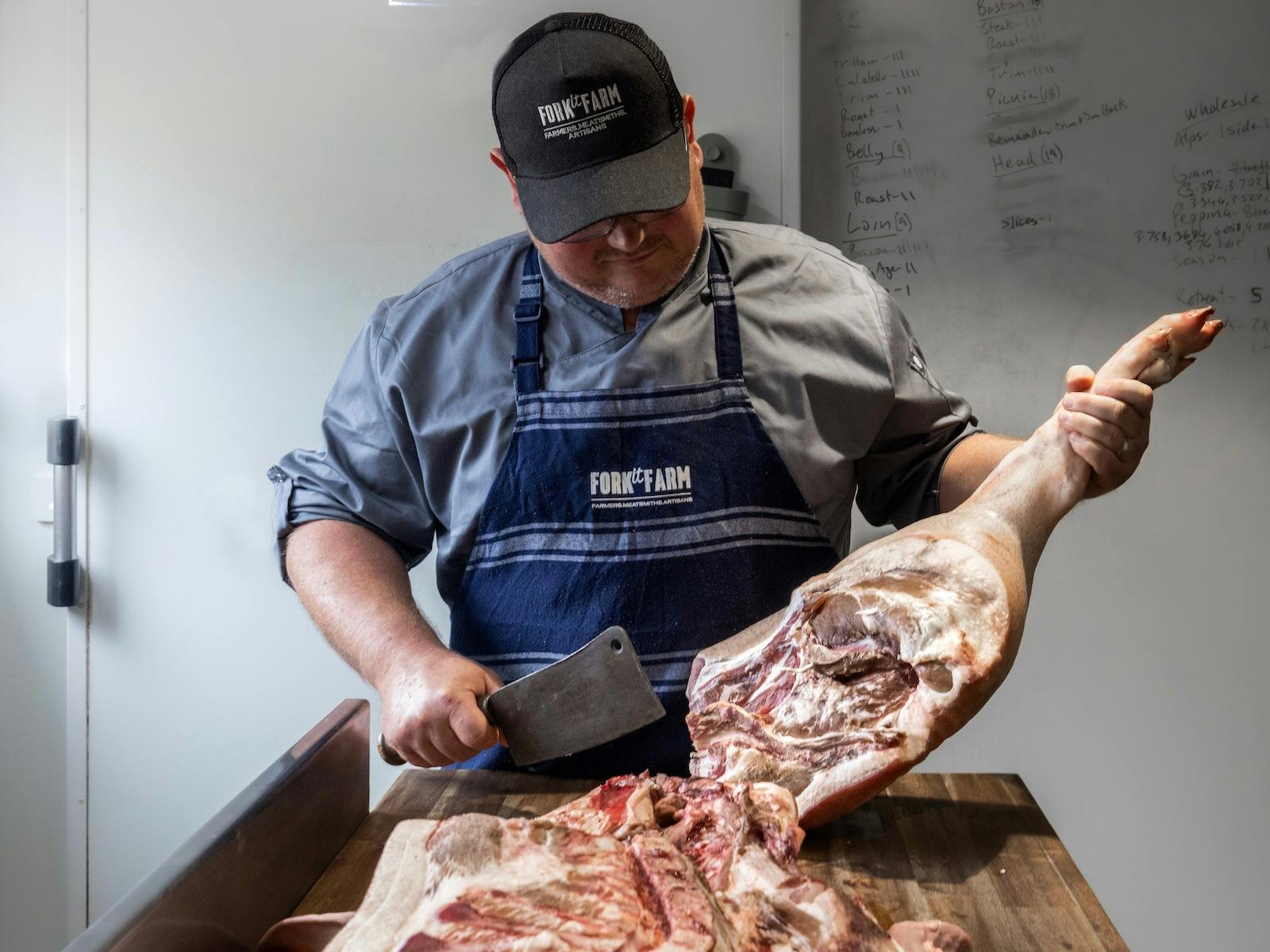 Daniel of Fork it Farm butchering a pig in the on farm butchery