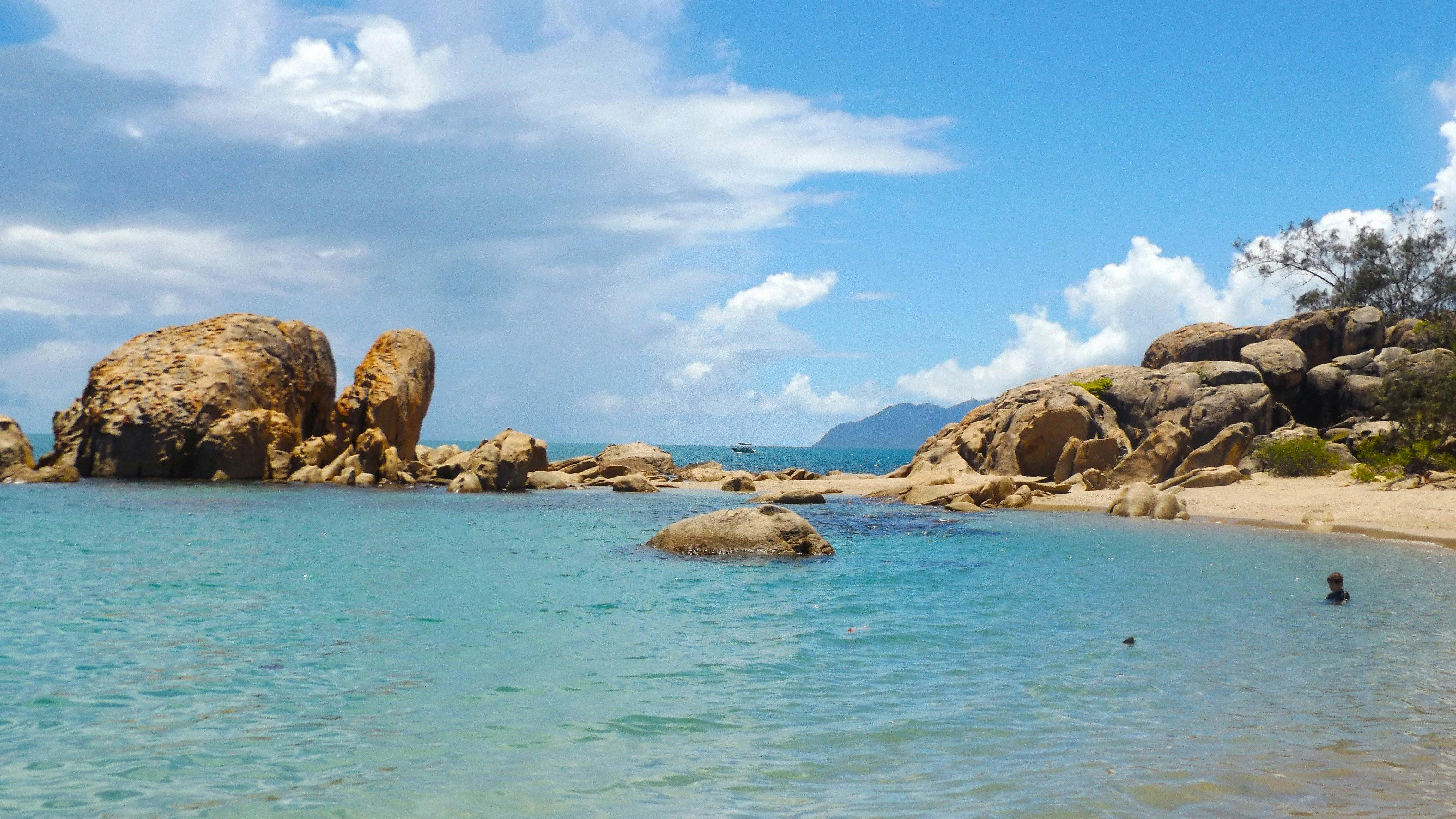 Blue water in protected bay surrounded by granite headland