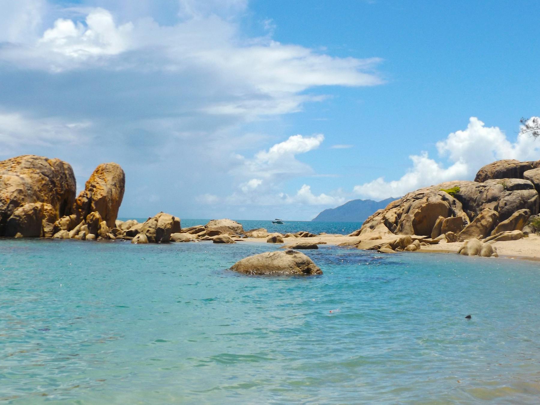 Blue water in protected bay surrounded by granite headland