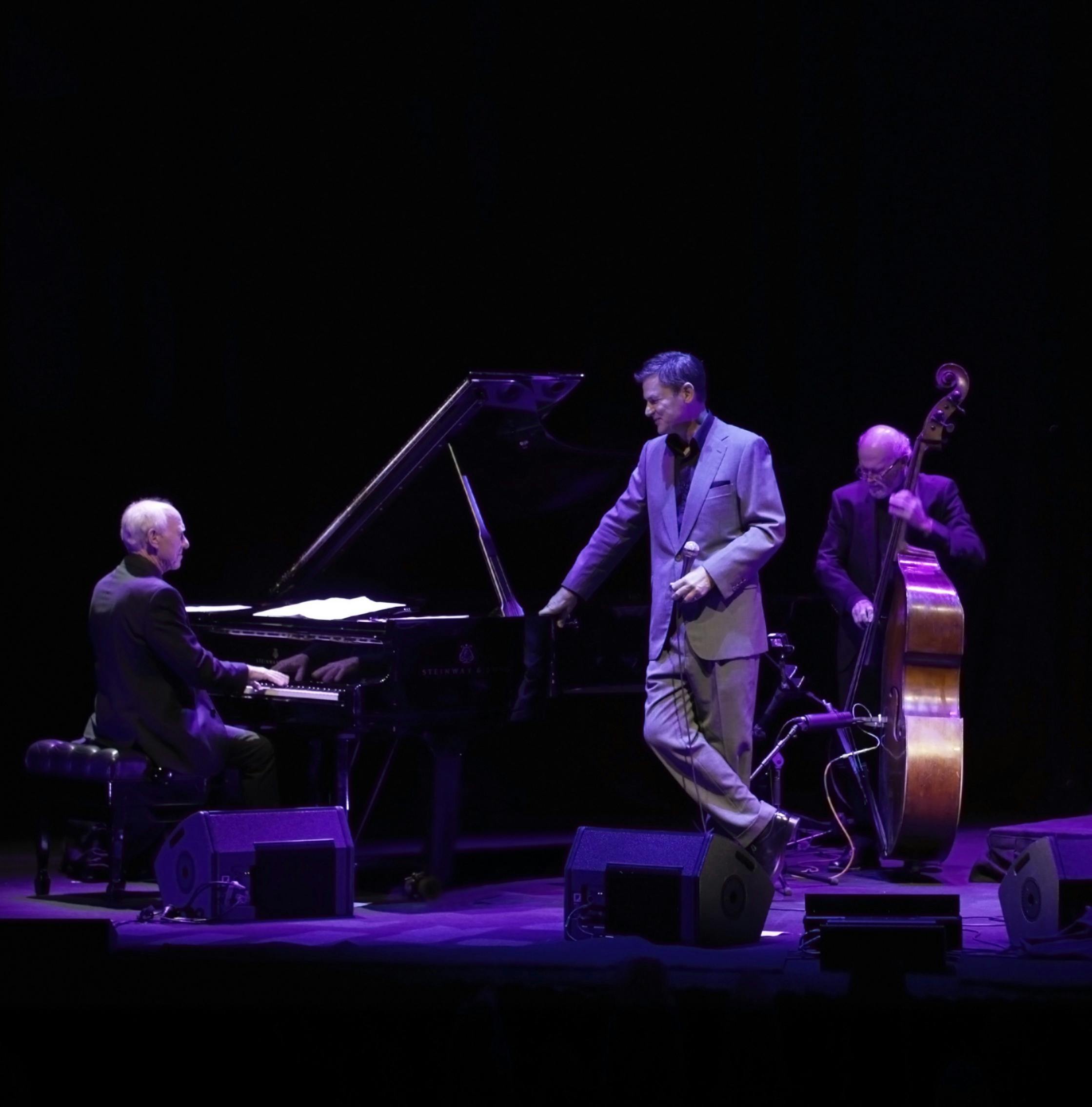 Man playing piano, vocalist and cello