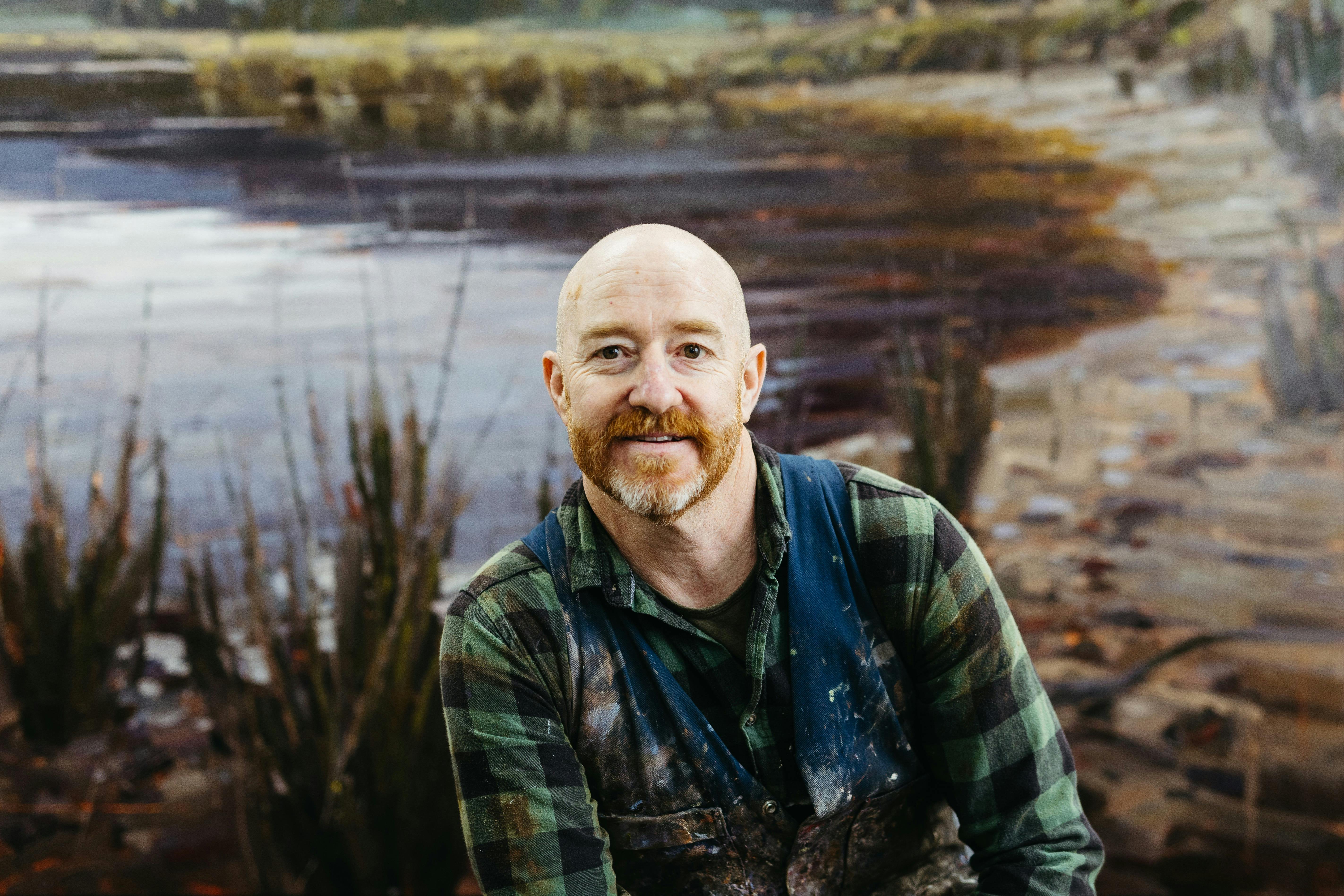 Clifford How pictured with an oil painting inspired by his time spent in Bathurst Harbour.
