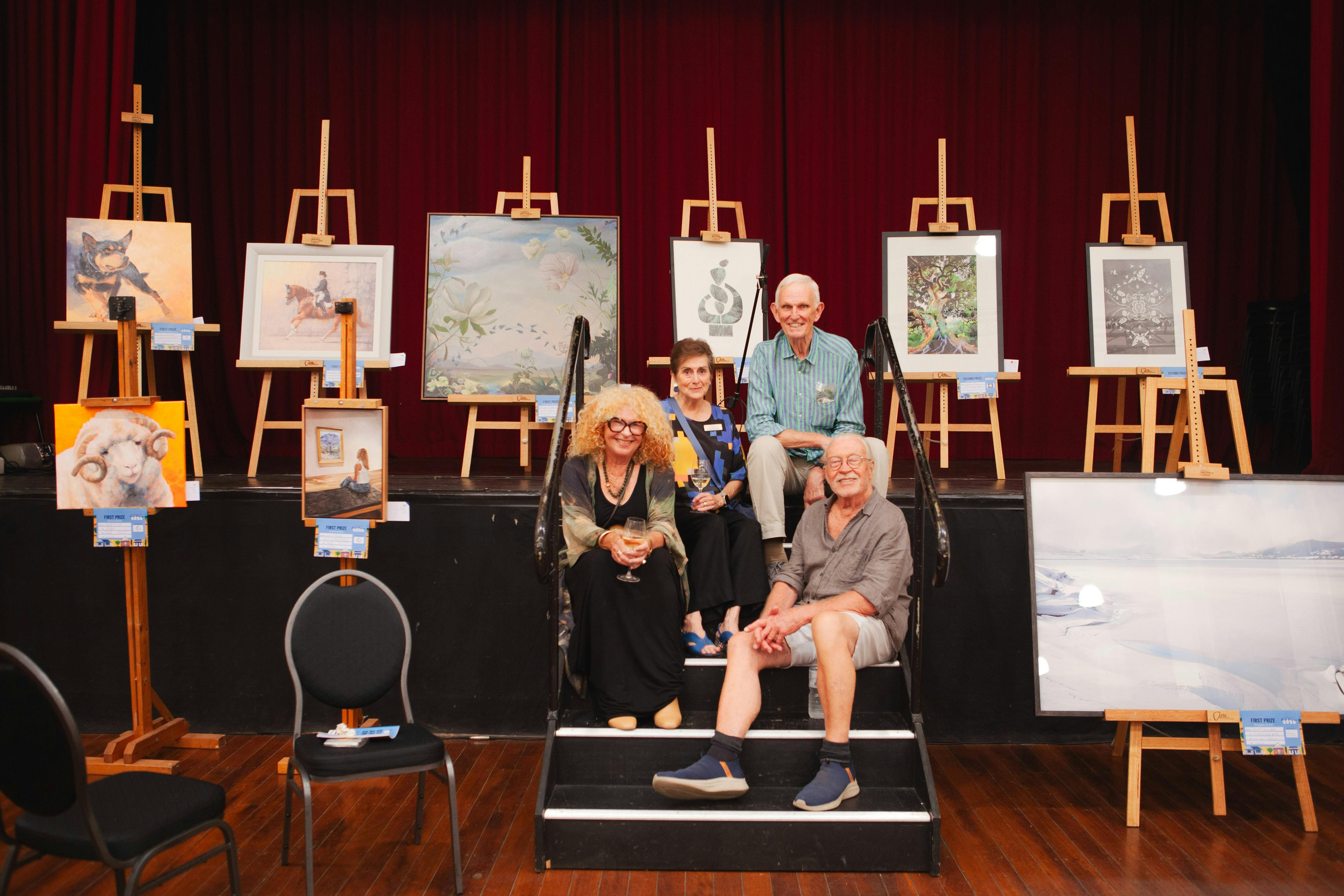 Group of friends sitting in front of the winning art worf
