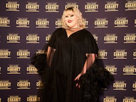 Charlee stands posing in black chiffon at the Adelaide Cabaret Festival