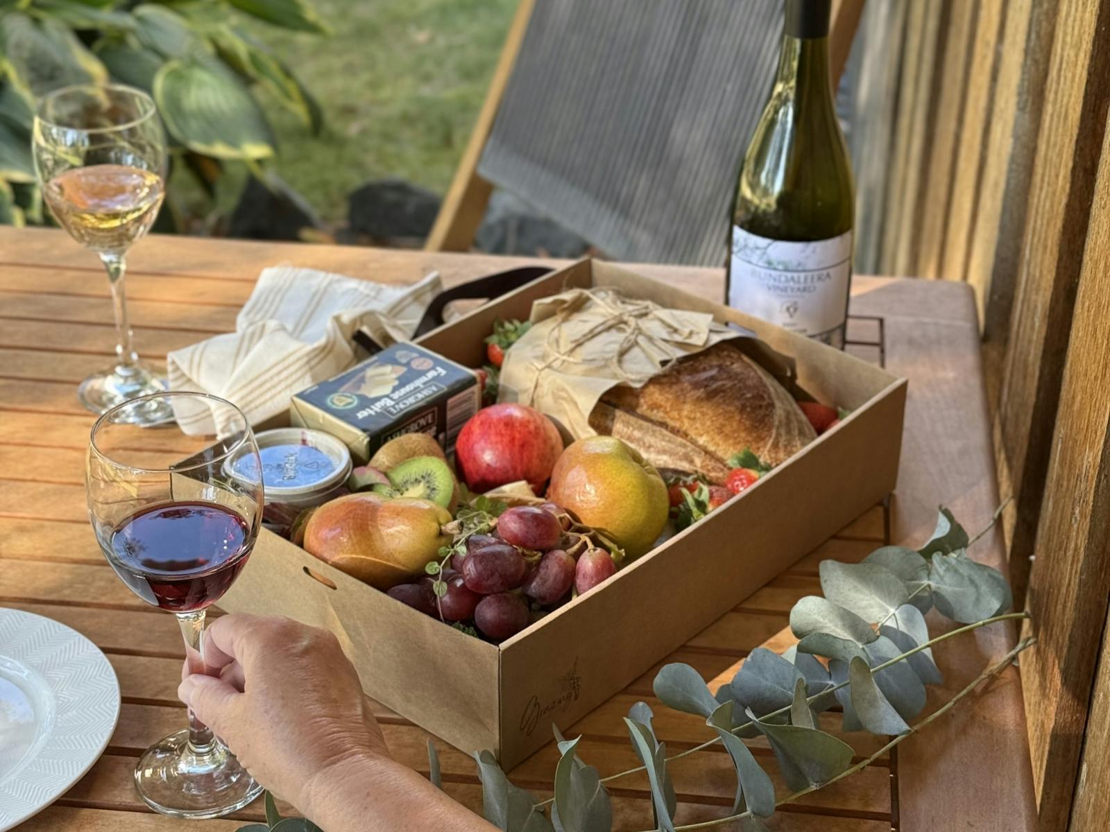 Bundaleera Vineyard and Farm Stay accommodation grazing box and wine glasses and bottle