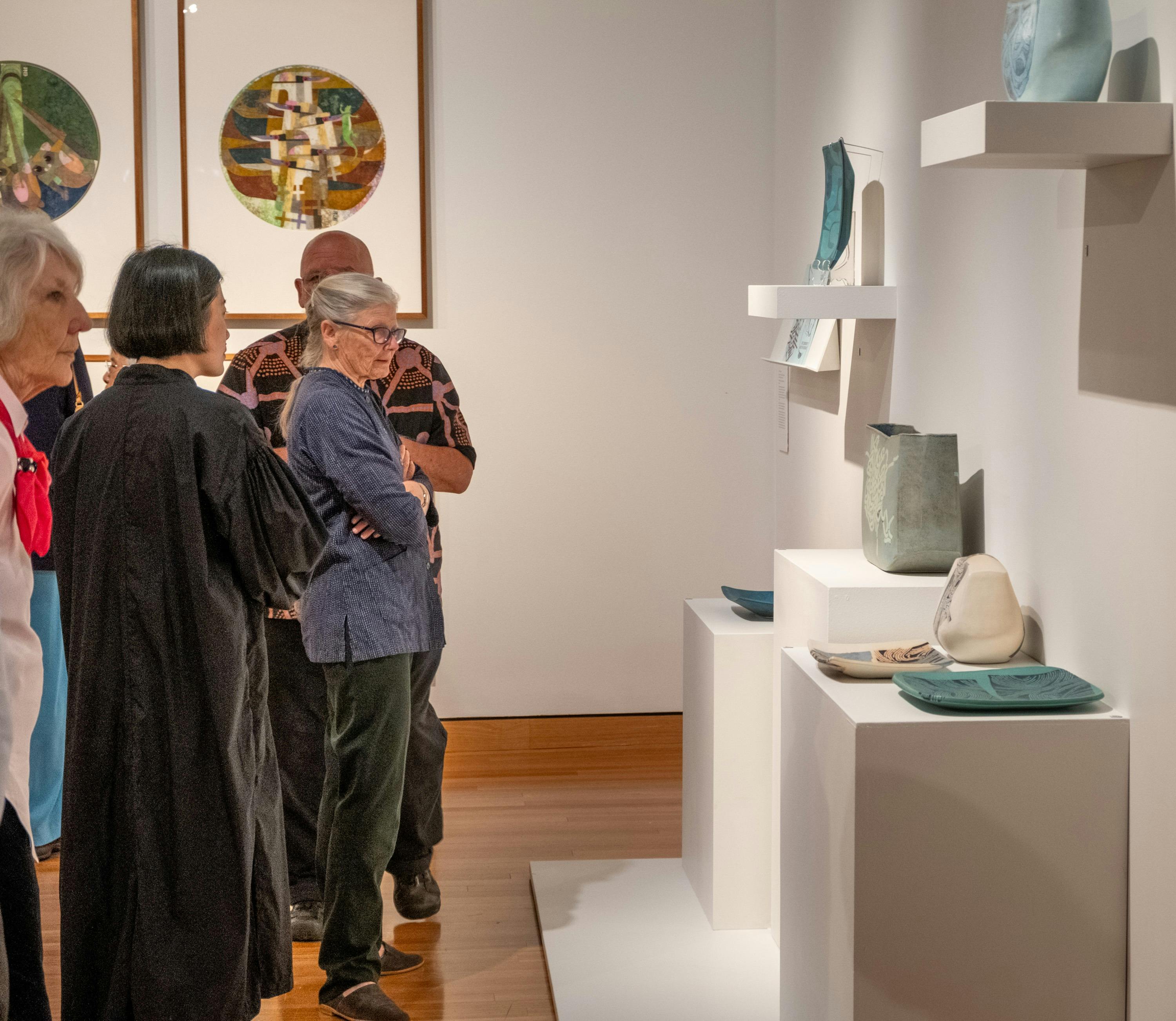 People observing Hiroe Swen's ceramics at Canberra Museum + Gallery