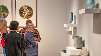 People observing Hiroe Swen's ceramics at Canberra Museum + Gallery
