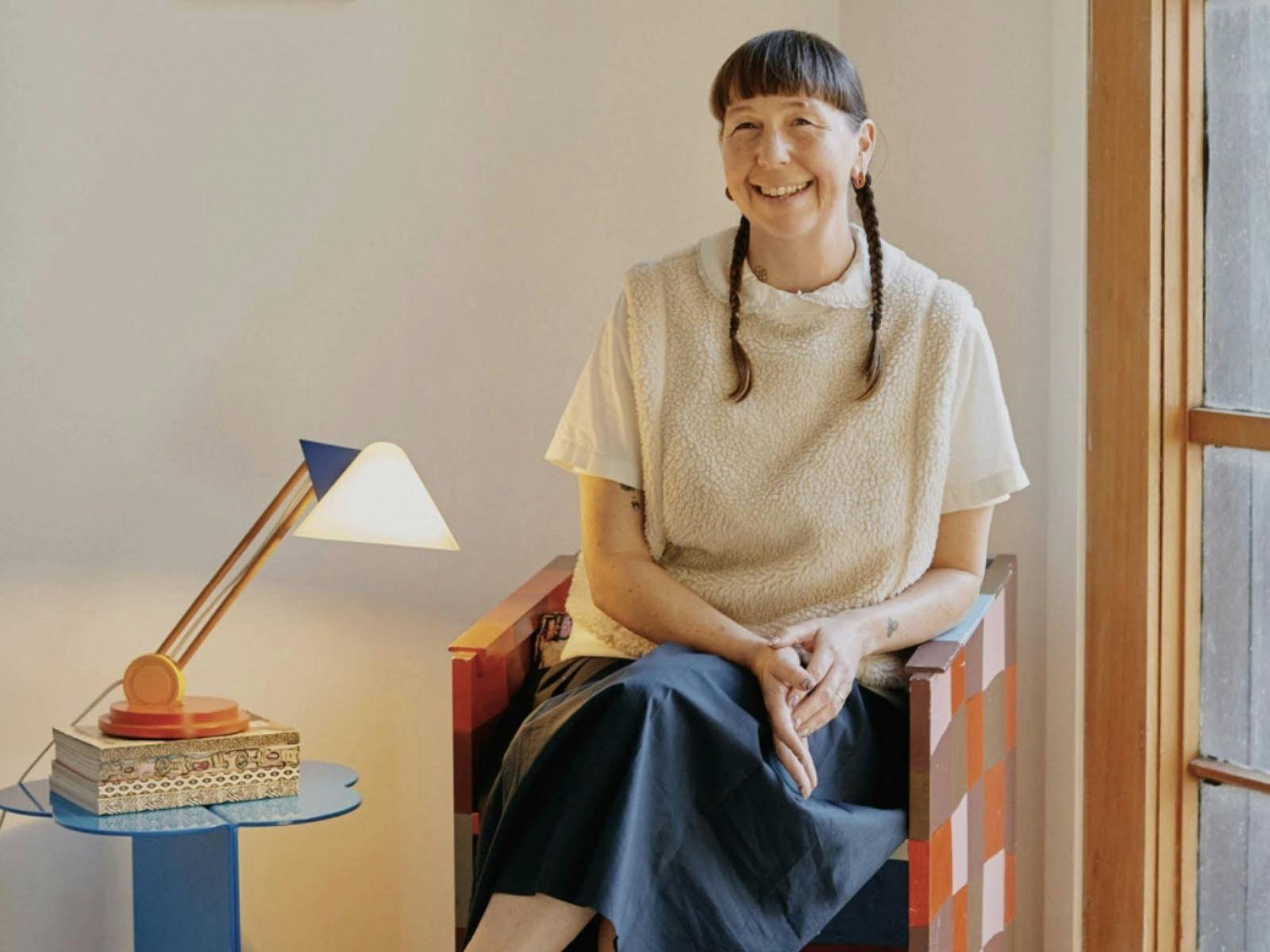 Beci Orpin, artist, sitting and smiling to camera