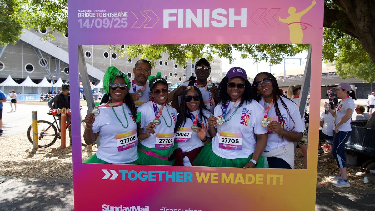 People having their photo taken inside an instagram frame that says Finish.