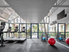 Fully equipped gymnasium with natural light and free weights