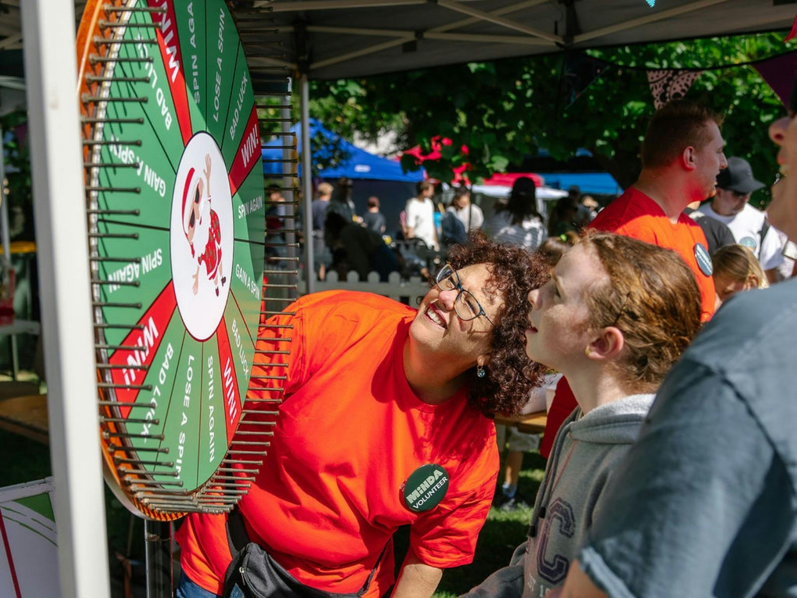 A visitor spins the wheel to win a prize