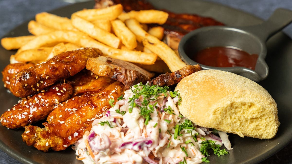 Brothers Carnivore plate with brisket, wings, ribs and slaw