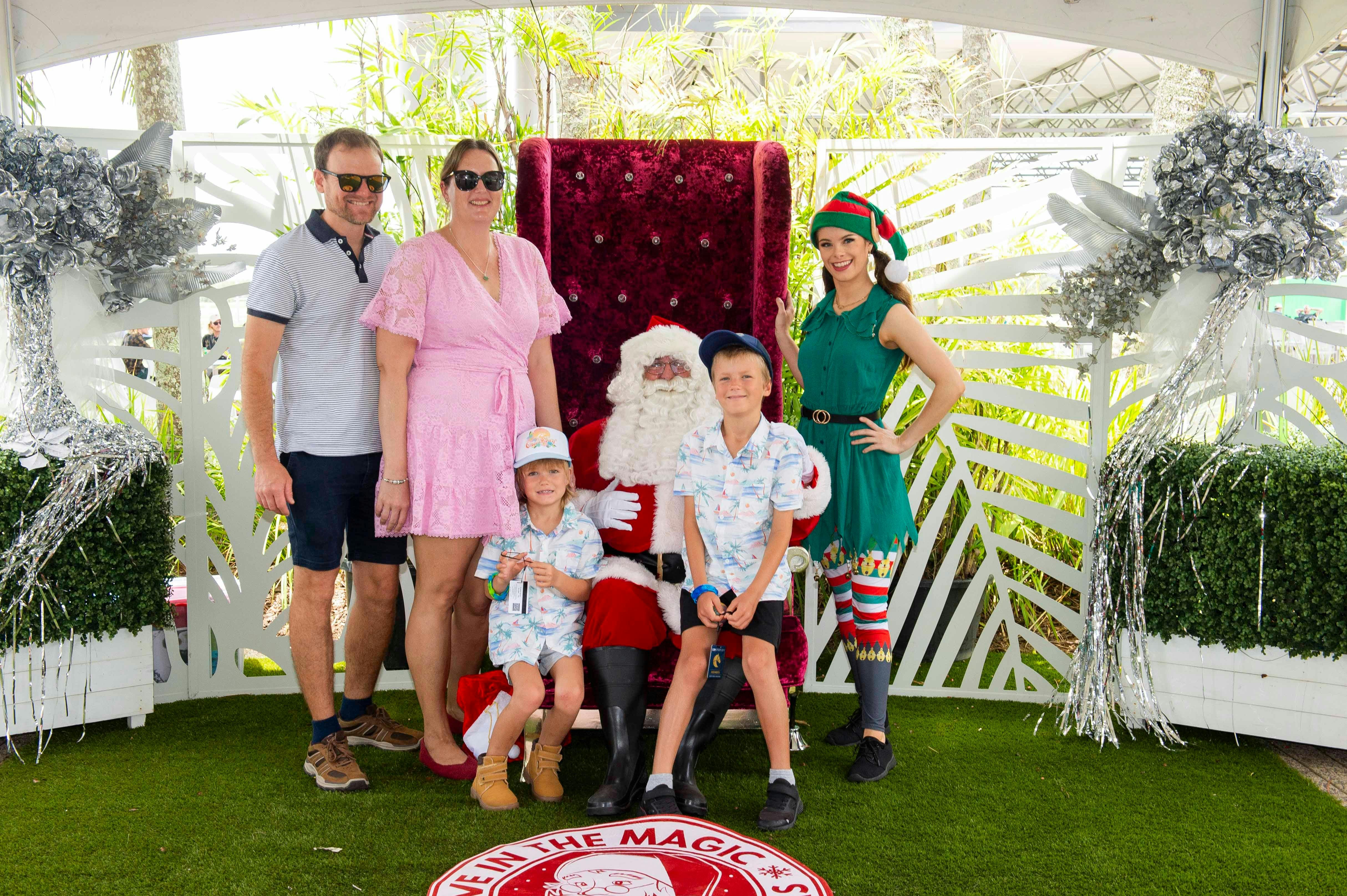 mum, dad, and 2 kids having their photo with santa