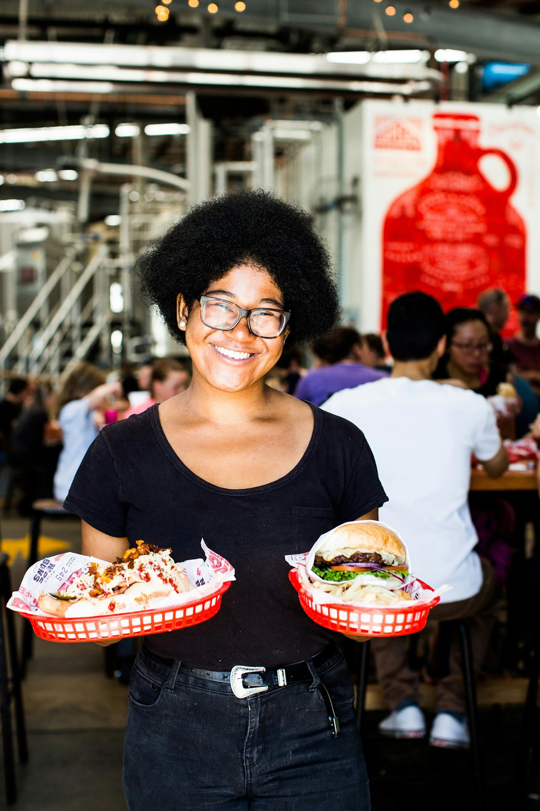 Lady holding burgers