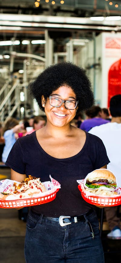 Lady holding burgers