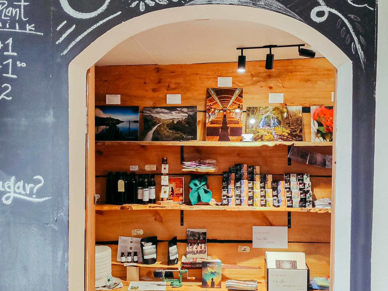 A photo of the Larder archway in the cafe with products lined on the wall.