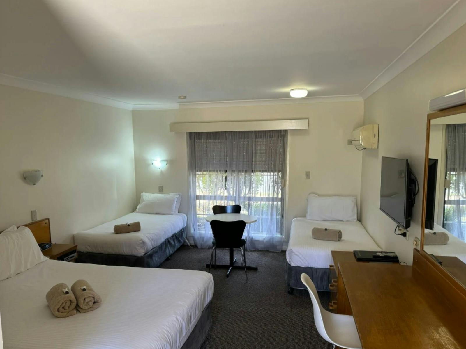 All Settlers Motor Inn Family room with Queen Bed with white linen and 2 single beds