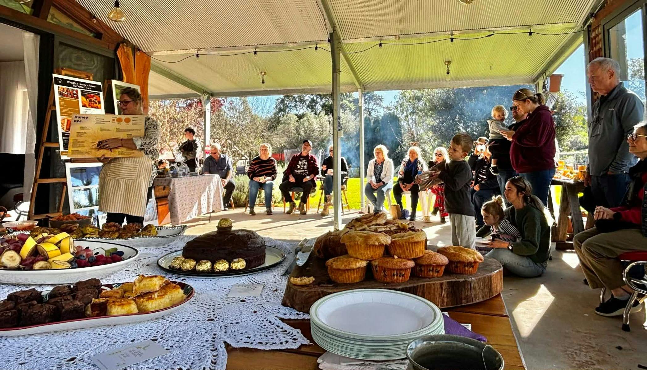 People sat listening to a honey workshop