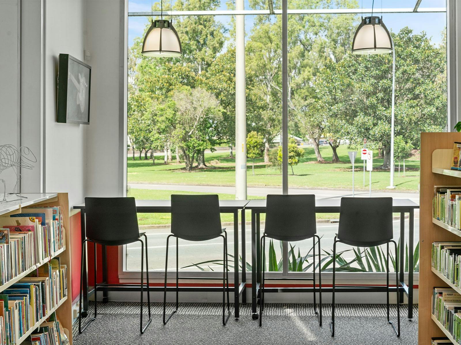 Image of seating in front of large windows for working .