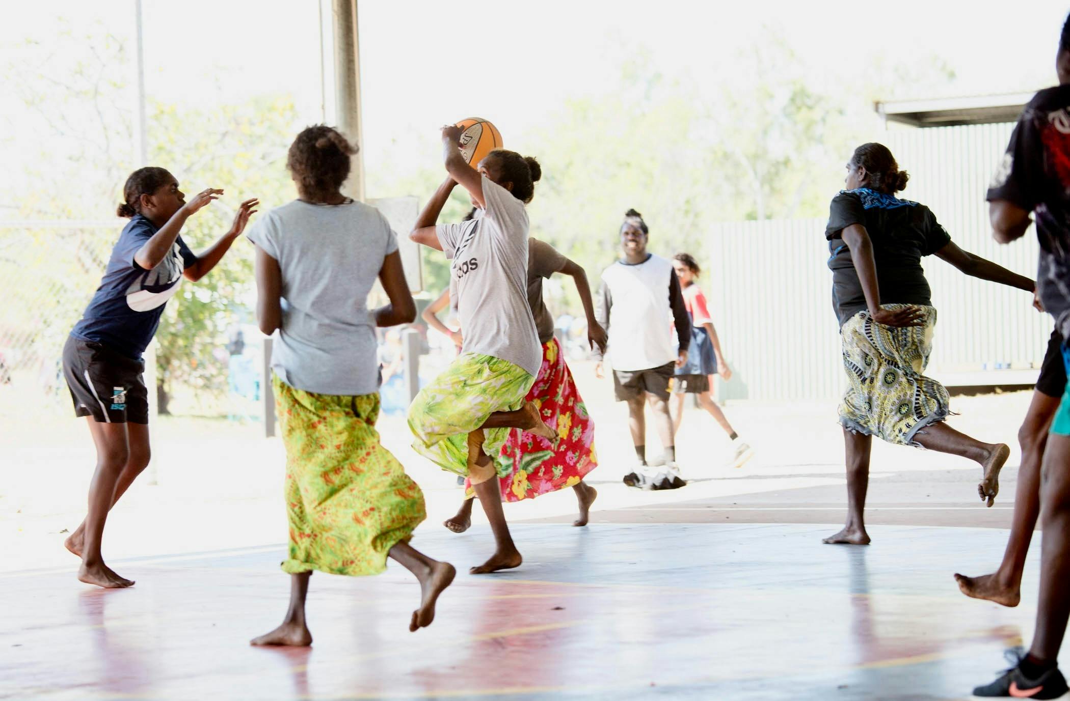Women playing basketball in barefoot